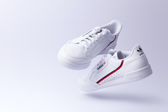 capture perfect product photos, product photography shoot of branded white sneakers with a white background