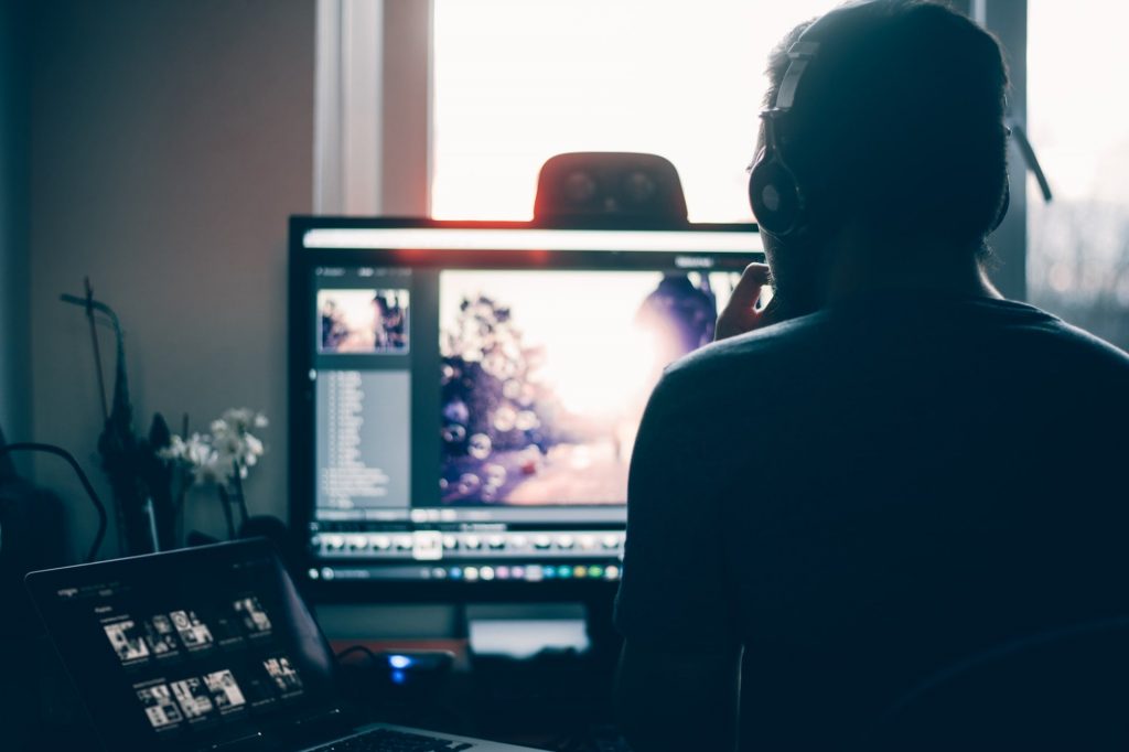Understanding the post-production process of a commercial photographer can help you get a better idea about what the results will look like; a person editing images on their computer and laptop