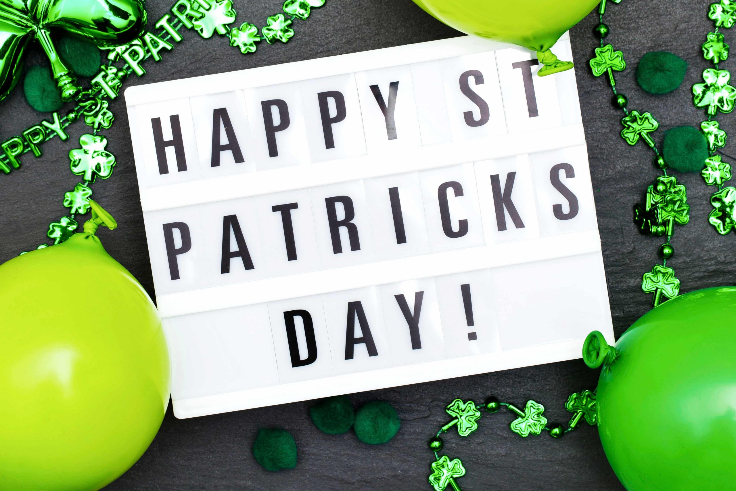 Commercial photography for St. Patrick’s Day, lightbox sign surrounded by green decorations.